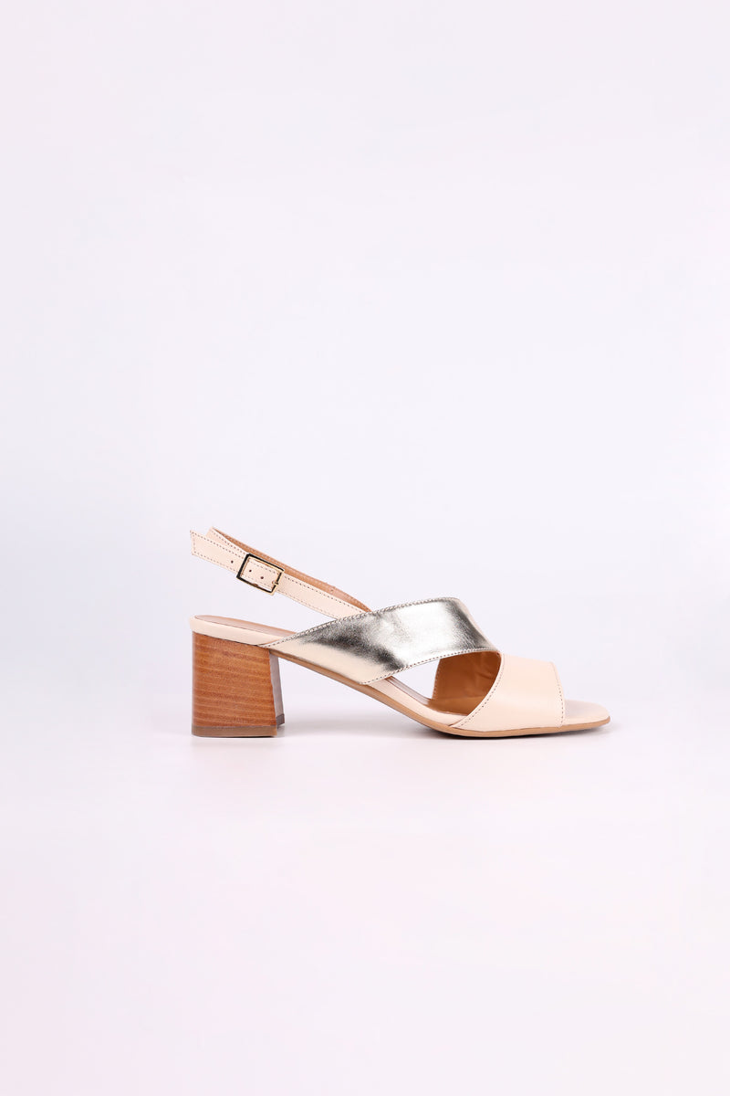Gold and Beige  sandal with wooden low heel on a light pink background