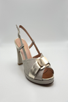 Platinum  sandal medium heels on a light gray background