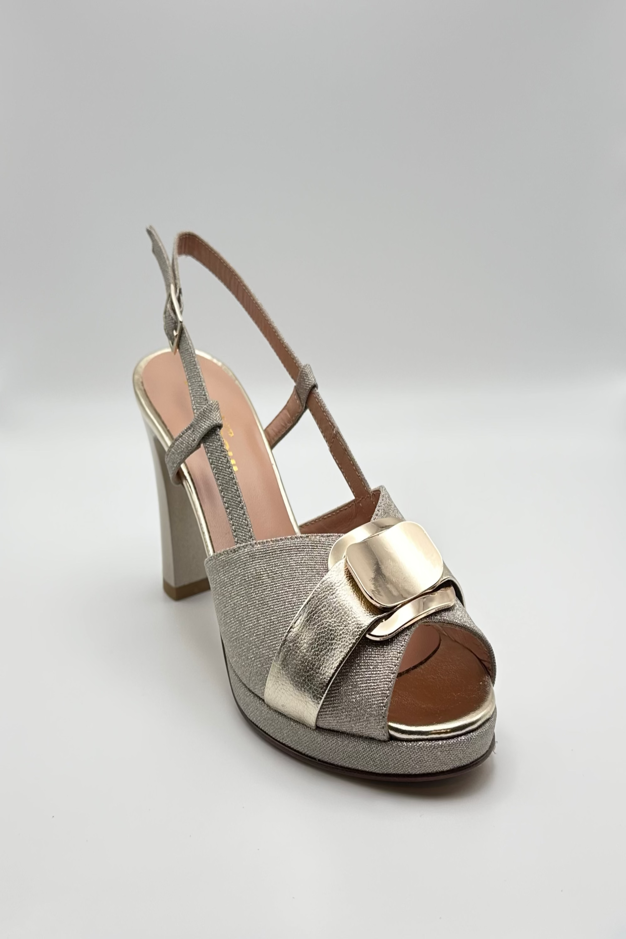 Platinum  sandal medium heels on a light gray background