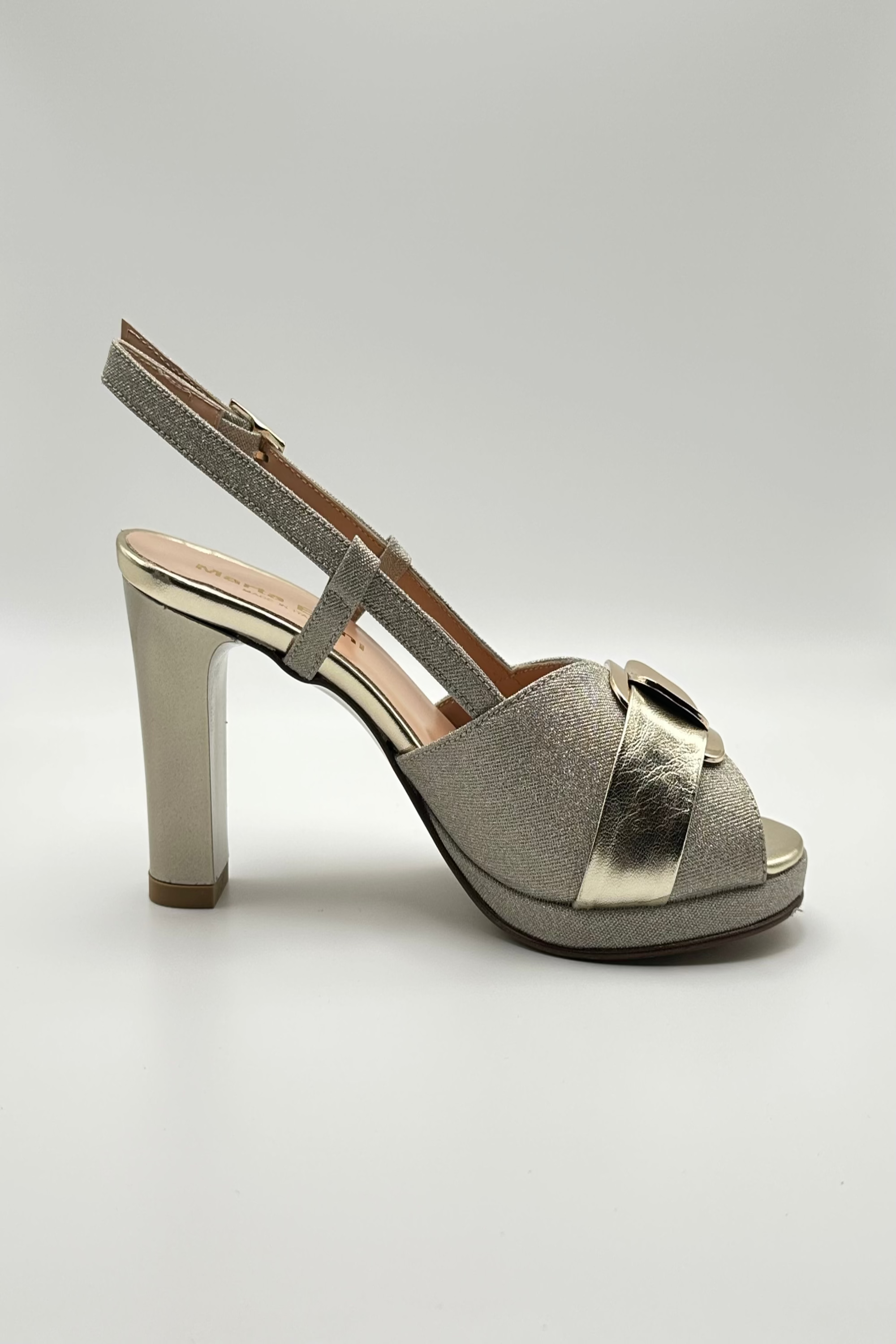 Platinum  sandal with a high heel on a light gray background