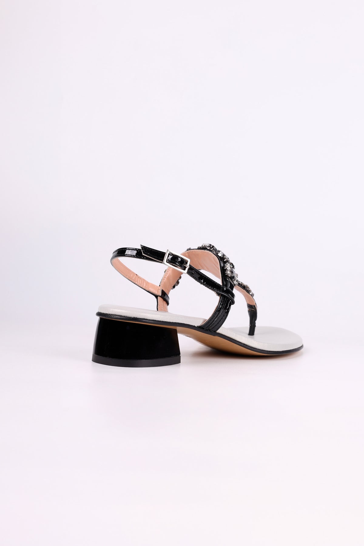 Black sandal low heel with a thin strap on a white background