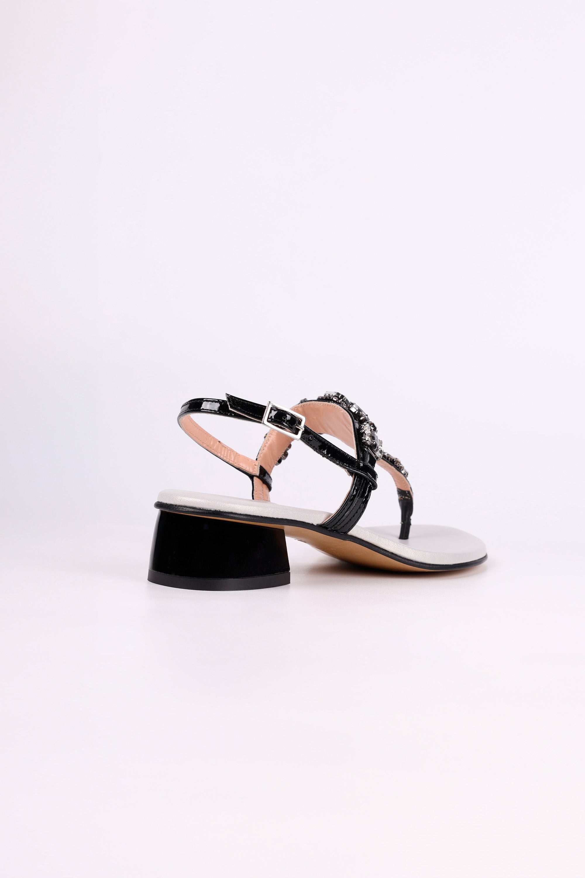 Black sandal low heel with a thin strap on a white background