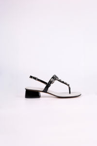 Black sandal low heels with gemstones on a white background