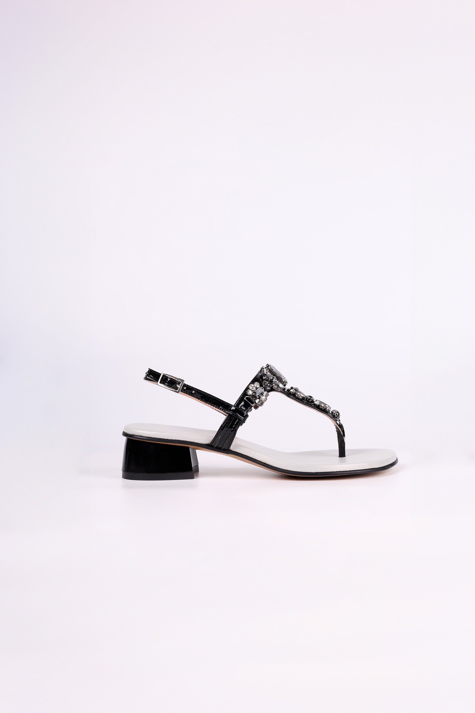 Black sandal low heels with gemstones on a white background