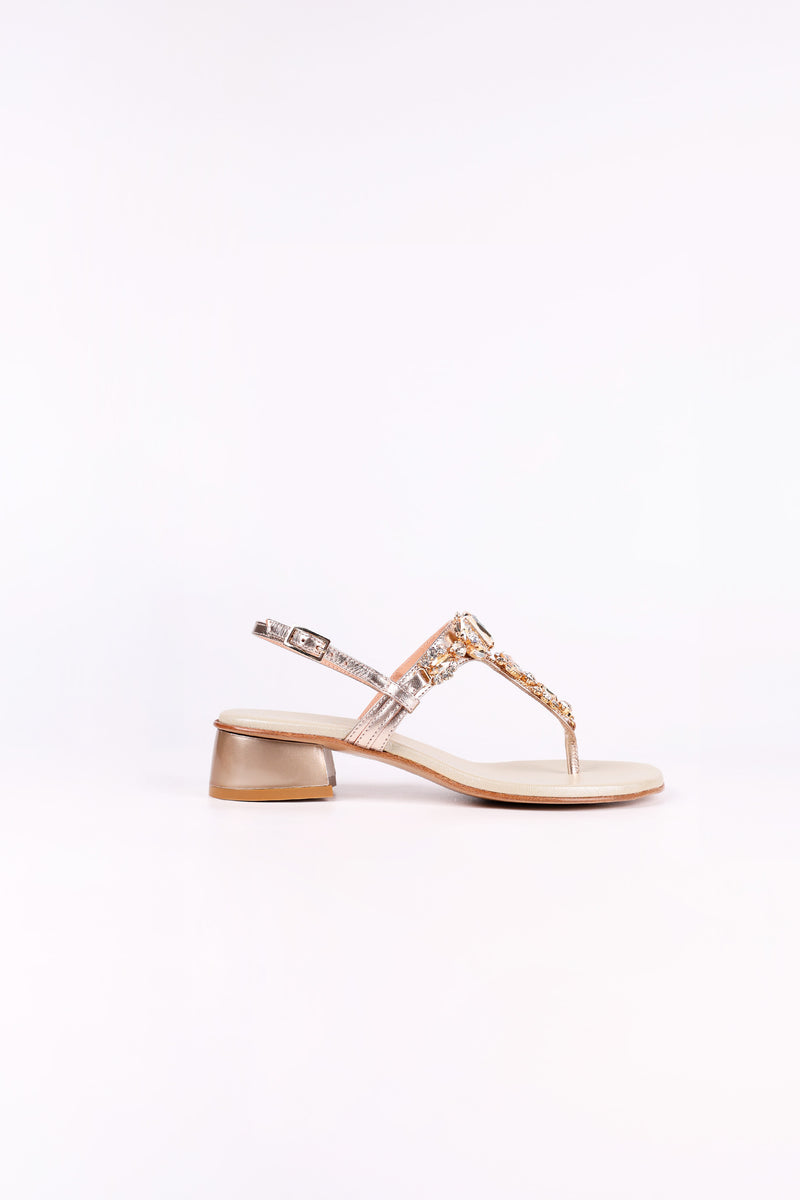 Platinum  sandal low heels with clear straps on a white background