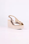 Platinum wedge sandal on a white background