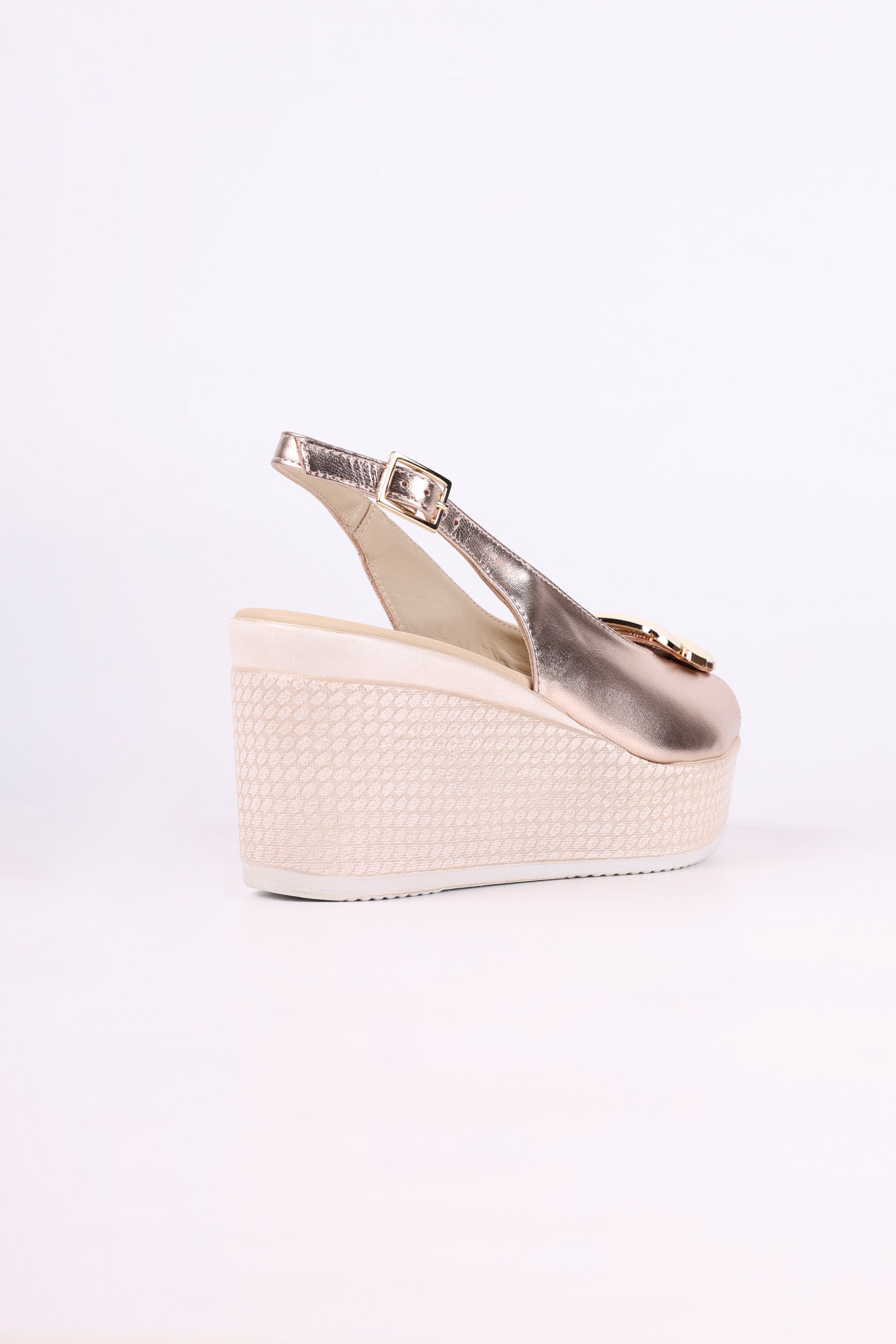 Platinum wedge sandal on a white background