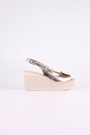 Platinum wedge sandal on a white background