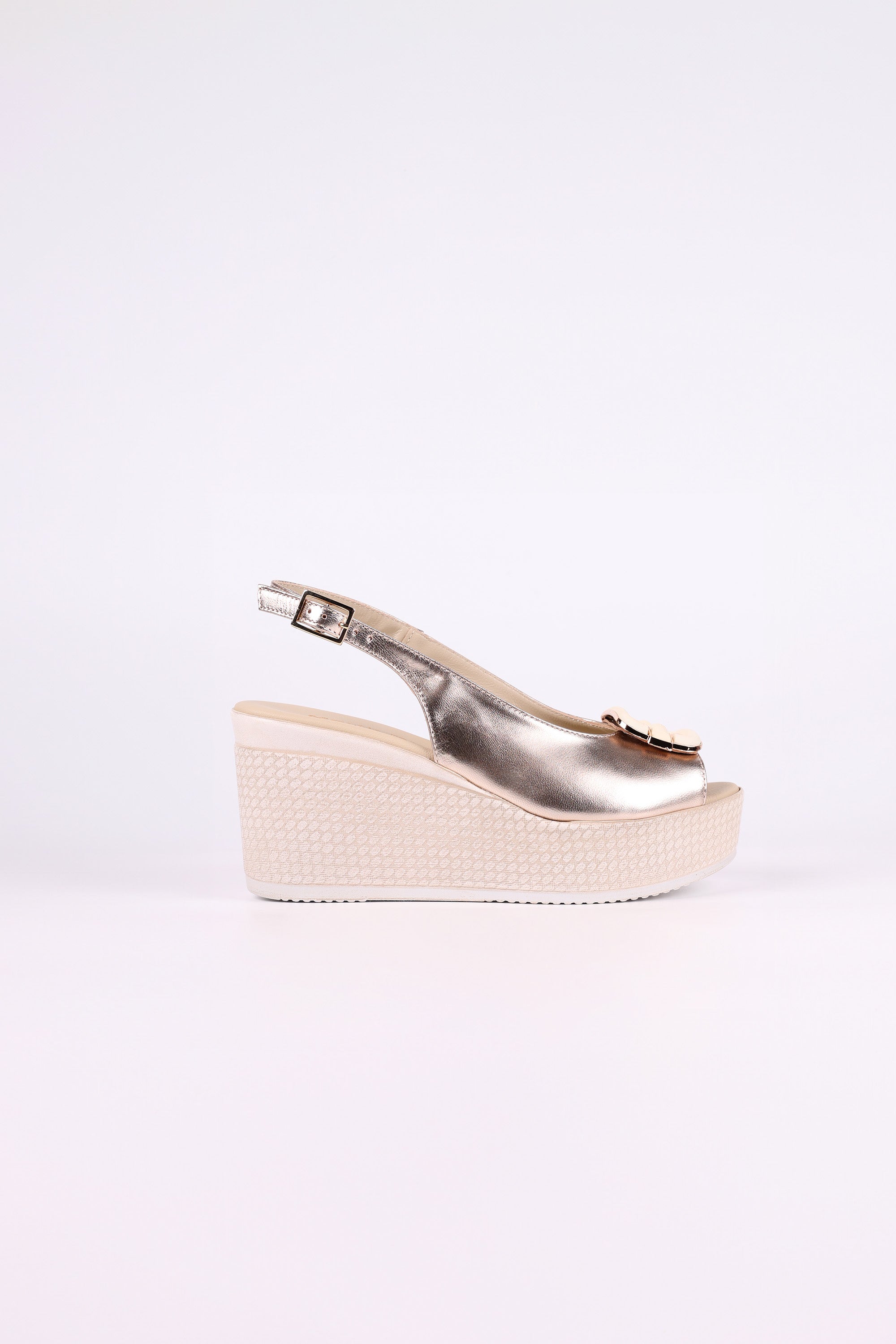 Platinum wedge sandal on a white background