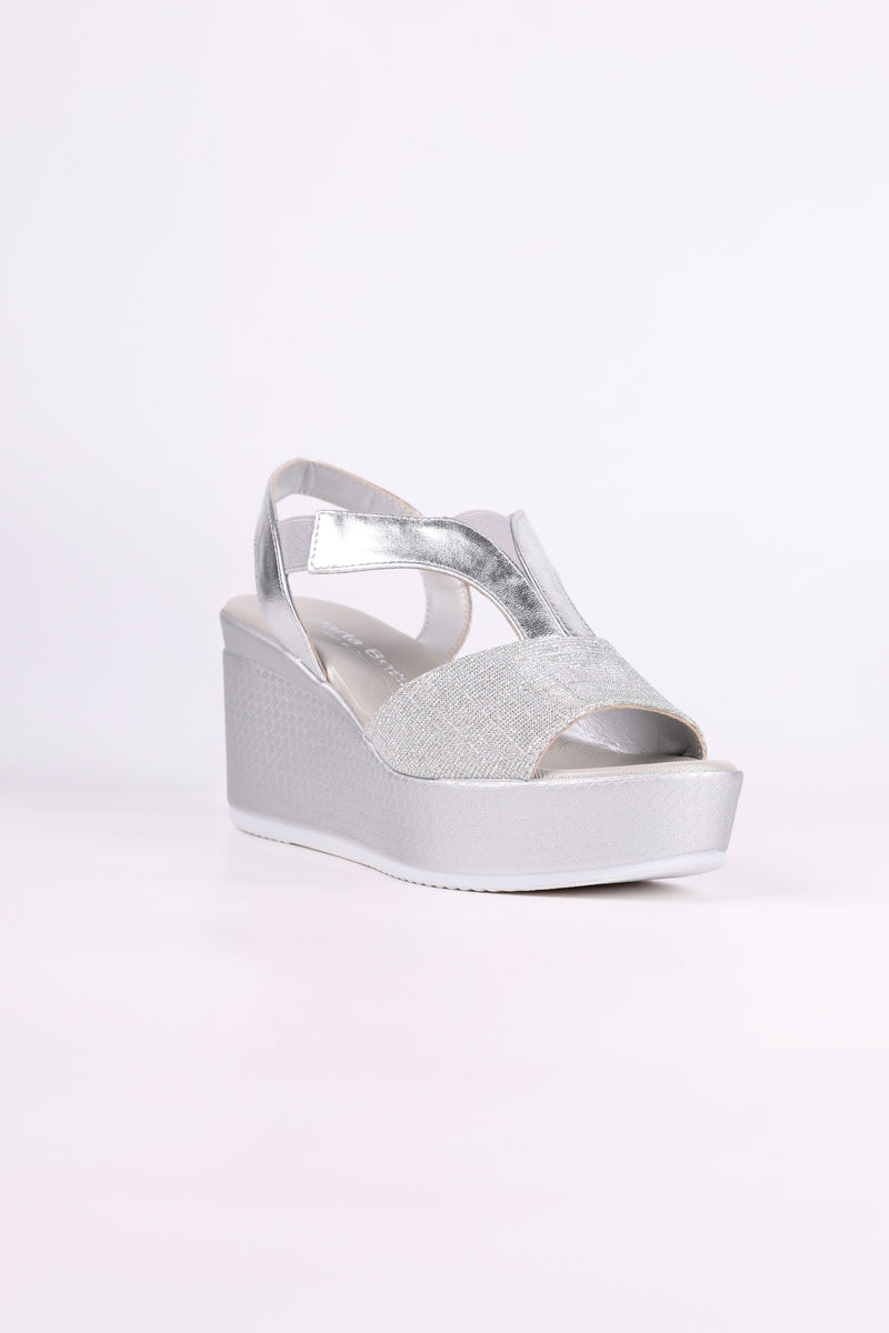 Silver wedge sandal on a white background