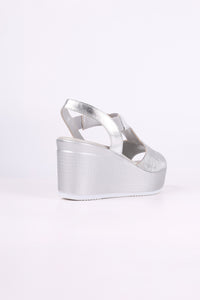 Silver wedge sandal on a white background