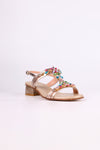 Platinum sandal low heels with colorful embellishments on a white background