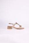 Platinum sandal low heels with colorful embellishments on a light pink background